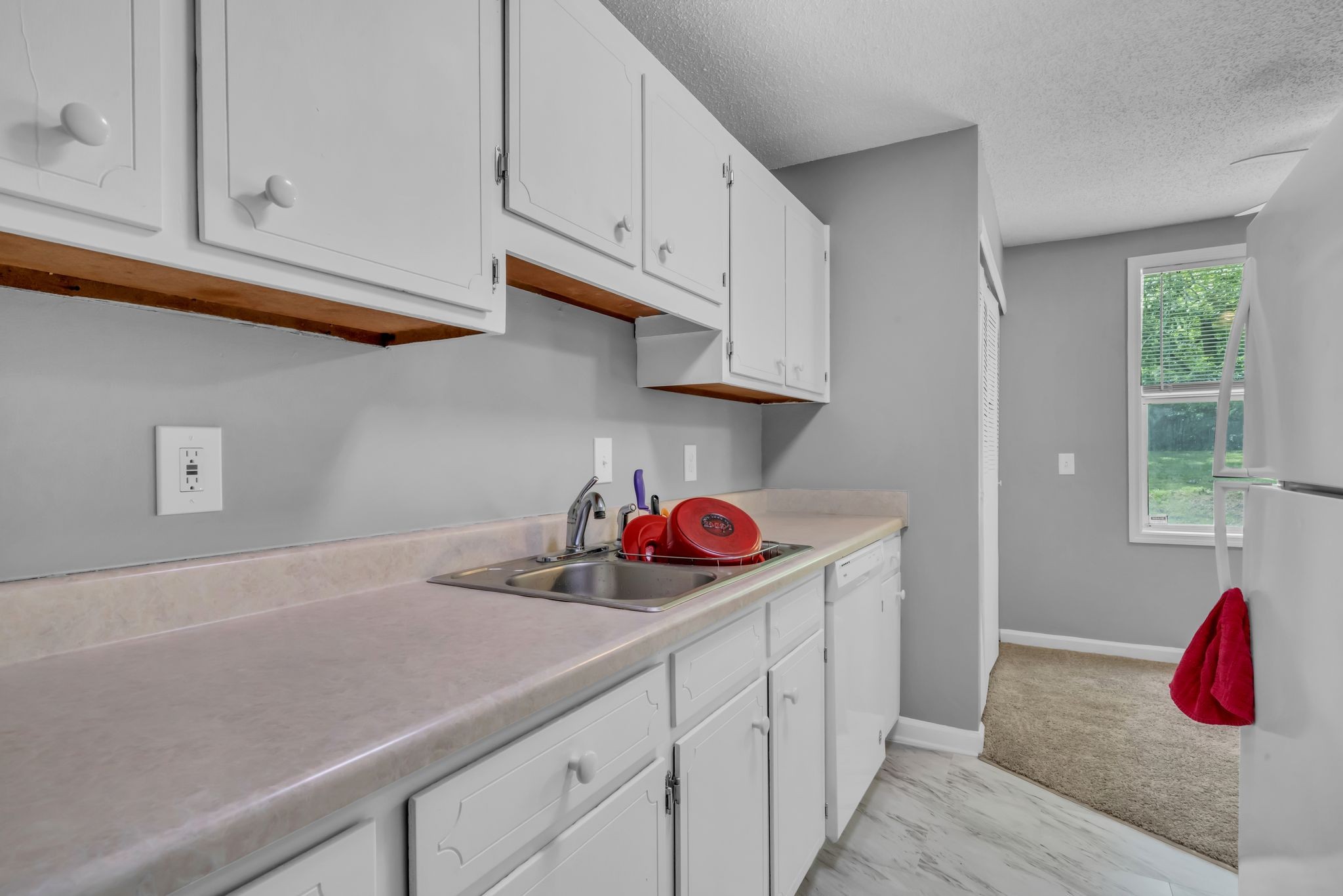 224 Warrior Road Madison, TN 37115 - Photo 9 of 27 a kitchen with a sink cabinets and window