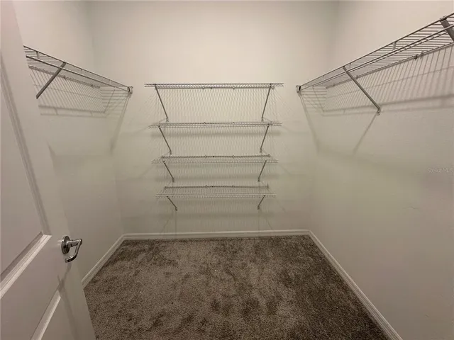a white toilet sitting in a bathroom next to a sink
