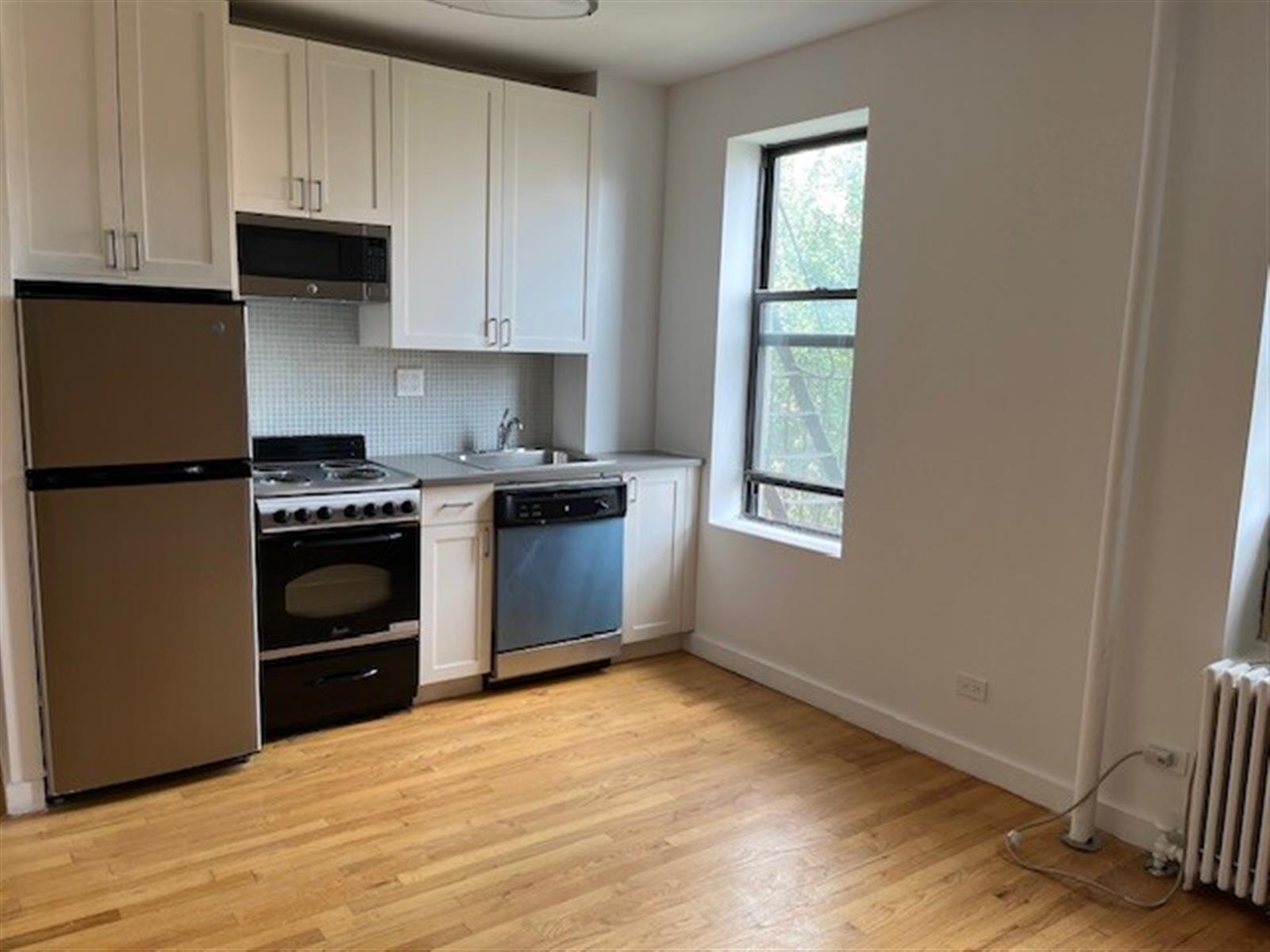 a kitchen with granite countertop wooden cabinets and a stove top oven