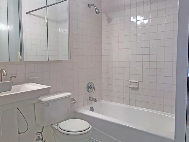 a bathroom with a bathtub toilet and sink