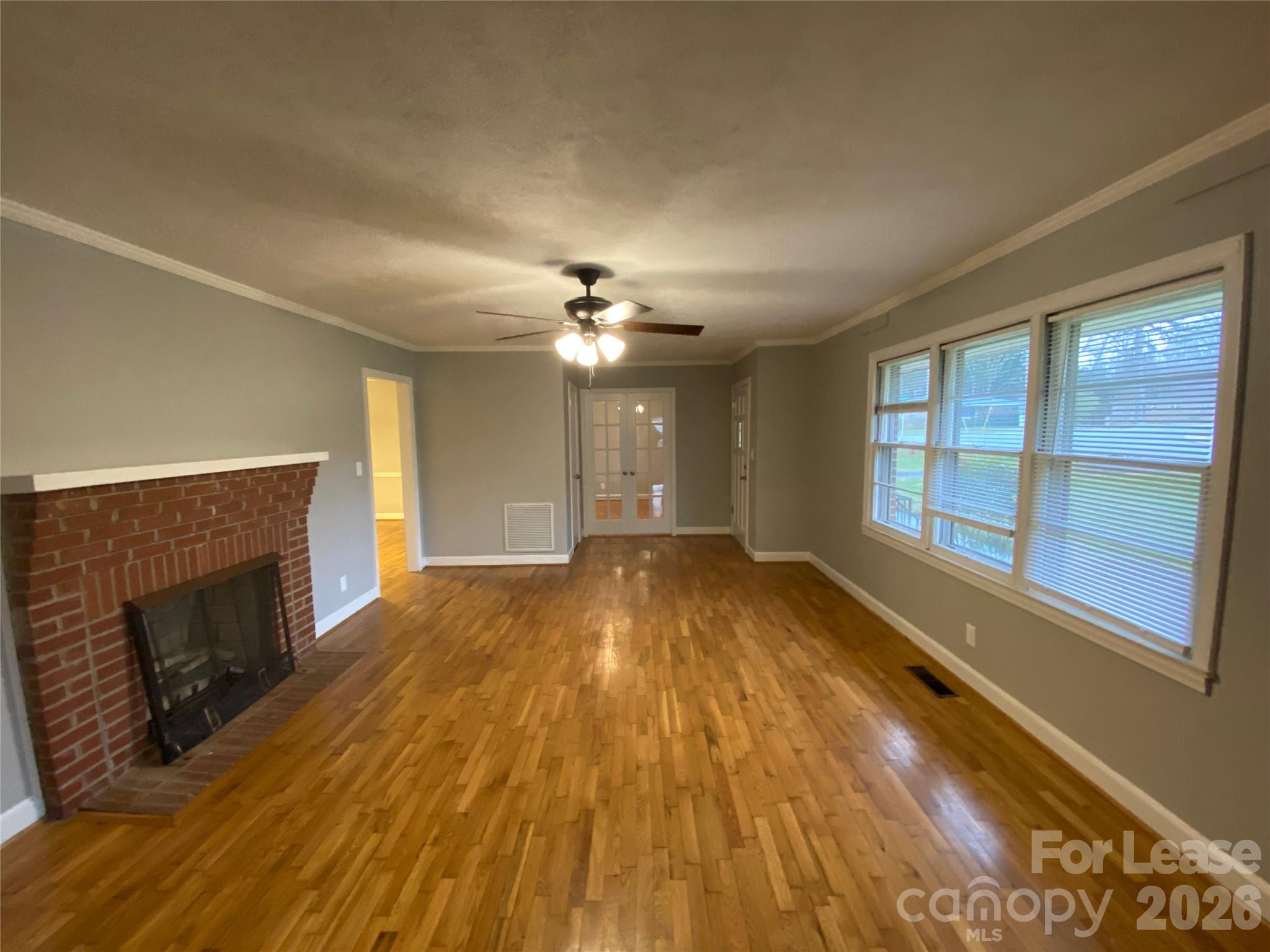 508 Dunham Road Gastonia, NC 28054 - Photo 3 of 16 a view of empty room with wooden floor and fireplace