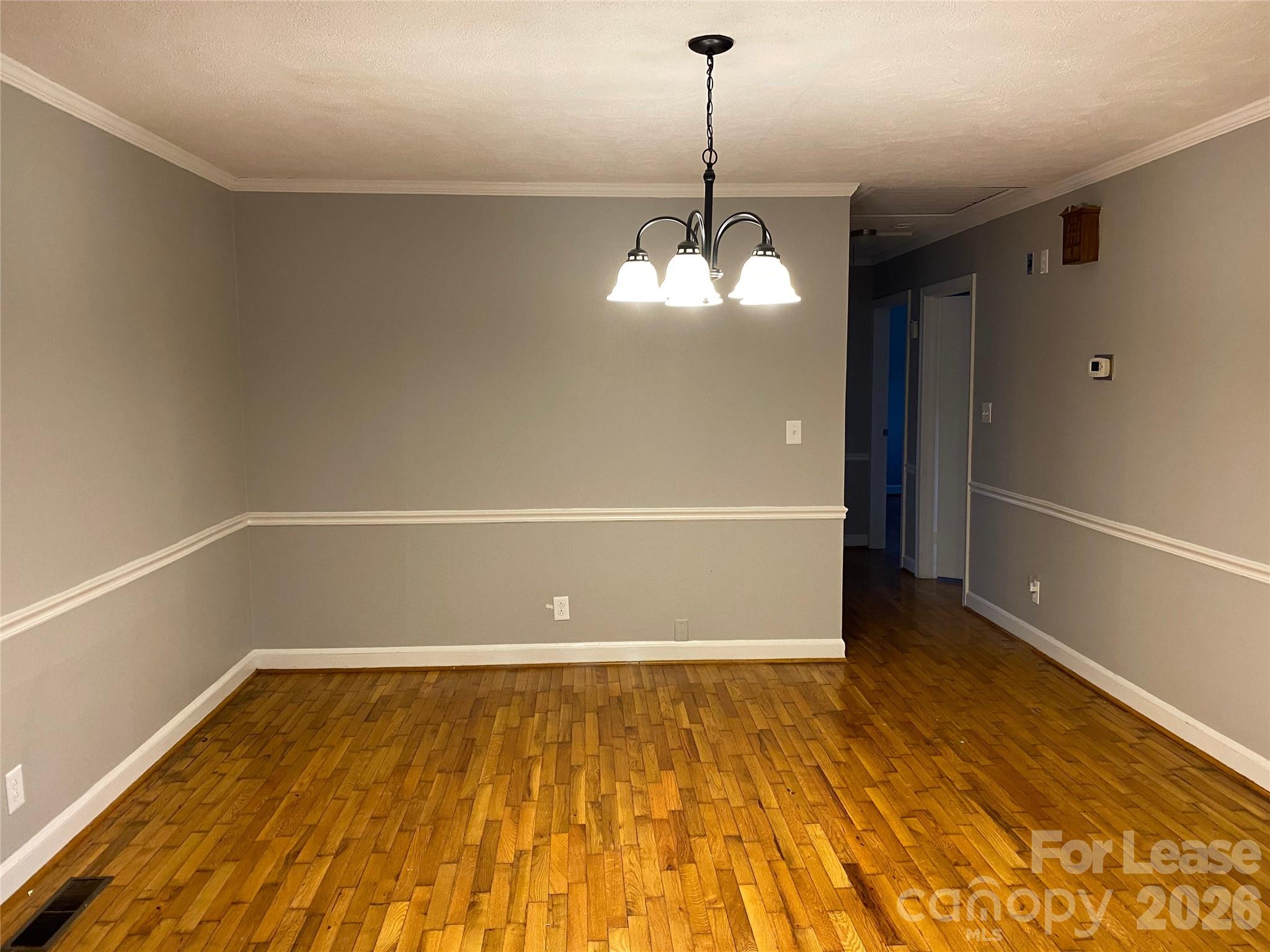 508 Dunham Road Gastonia, NC 28054 - Photo 4 of 16 a view of a room with wooden floor and kitchen view