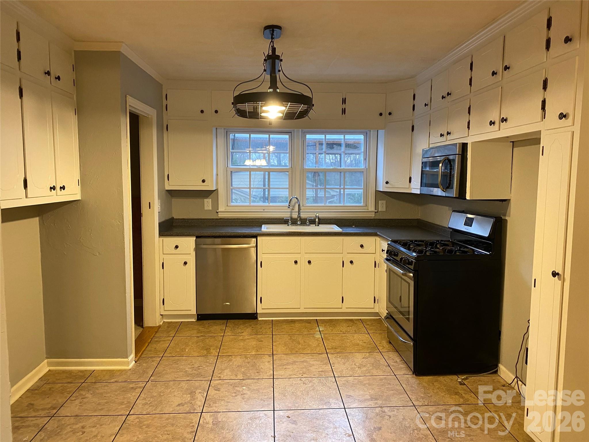 508 Dunham Road Gastonia, NC 28054 - Photo 5 of 16 a kitchen with a stove sink and cabinets