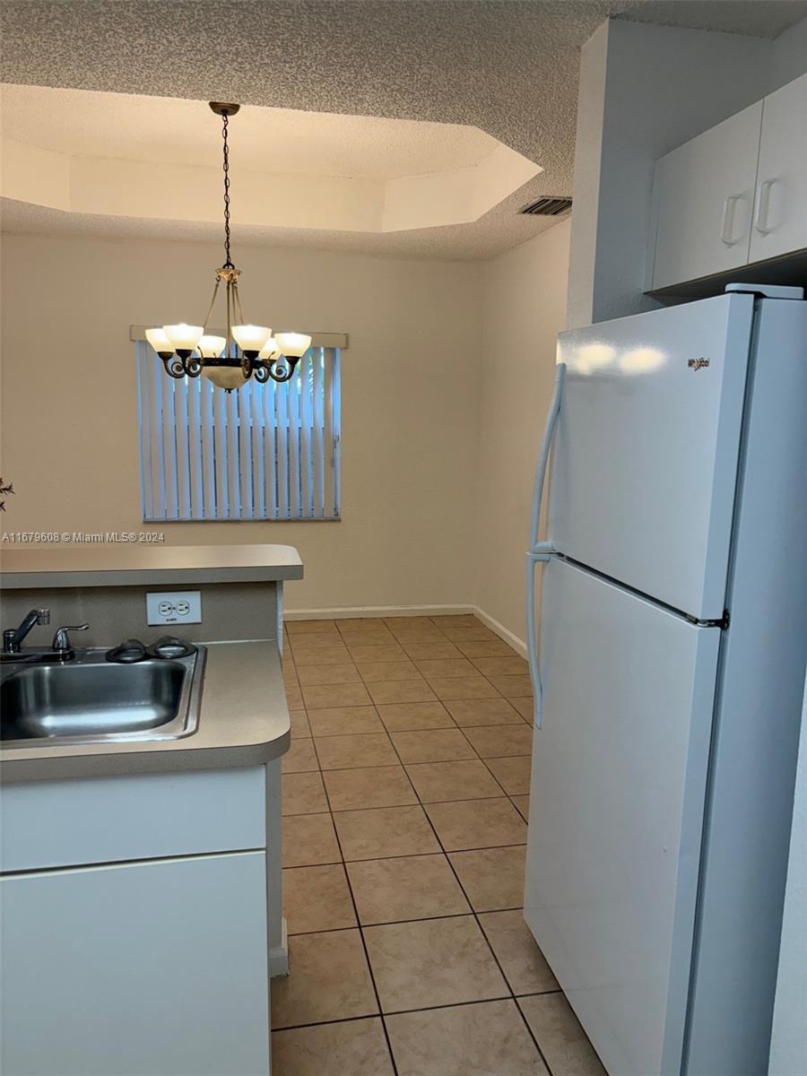 Three Lakes Miami, FL 33186 - Photo 11 of 34 a kitchen with a refrigerator and a sink