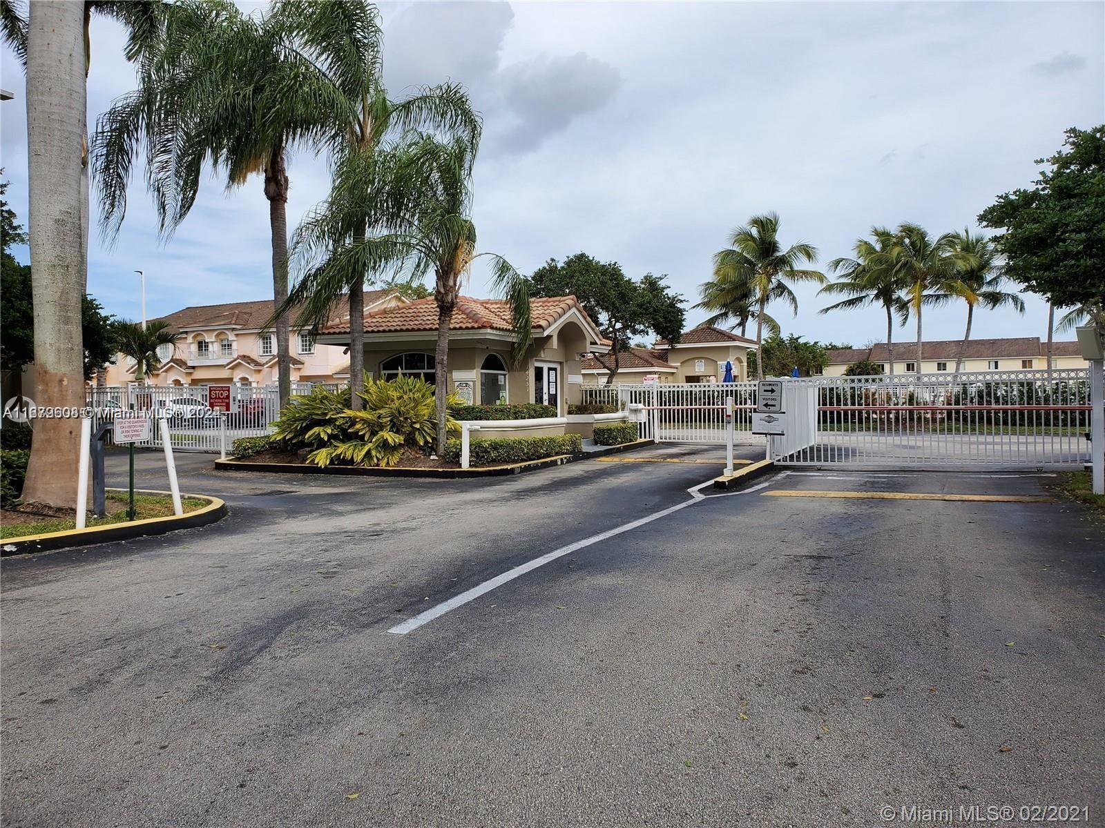 Three Lakes Miami, FL 33186 - Photo 2 of 34 a view of a street with a cars parked and small park