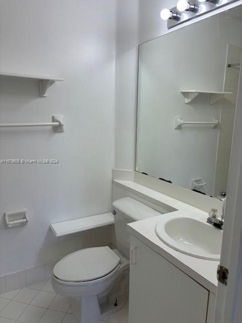 Three Lakes Miami, FL 33186 - Photo 22 of 34 a bathroom with a sink a toilet and a mirror