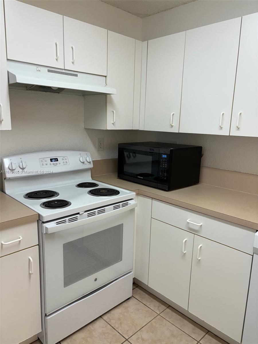 Three Lakes Miami, FL 33186 - Photo 10 of 34 a stove top oven sitting inside of a kitchen