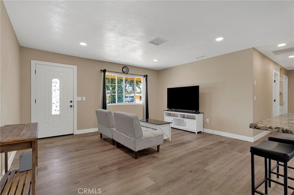 15471 Washoan Road Apple Valley, CA 92307 - Photo 6 of 38 a living room with furniture and a flat screen tv