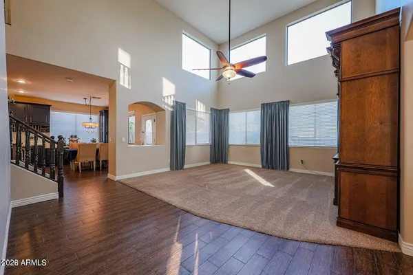 a view of a hallway with wooden floor and a kitchen