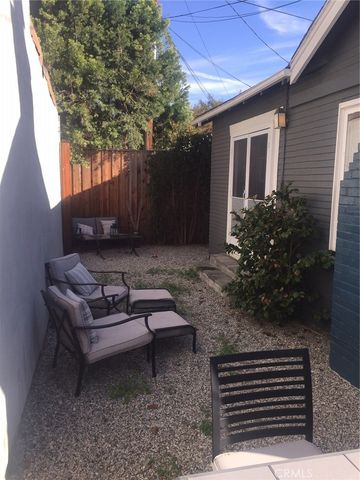 a wooden bench sitting in backyard of a house