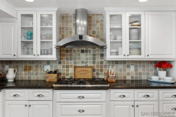 a kitchen with granite countertop a sink and cabinets