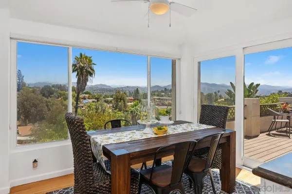 a view of a dining room with furniture window and outside view
