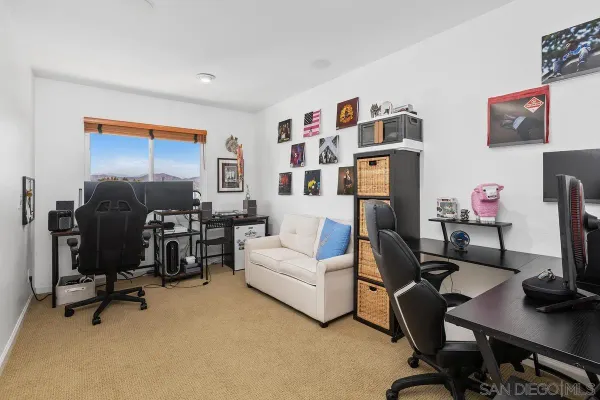 a livingroom with workspace and a couch