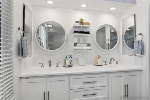 a bathroom with a double vanity sink and a mirror