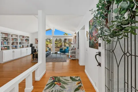 a hallway with dining area and chandelier