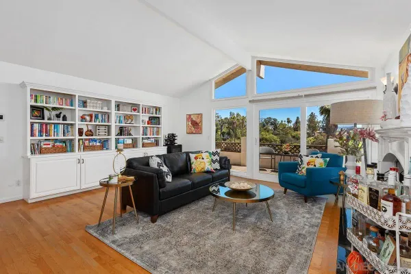 a living room with furniture and a floor to ceiling window