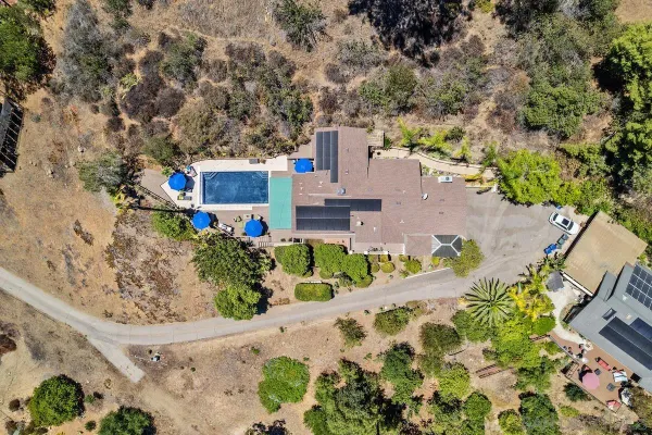 an aerial view of a house with a yard