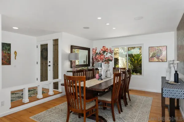 a view of a dining room with furniture and wooden floor