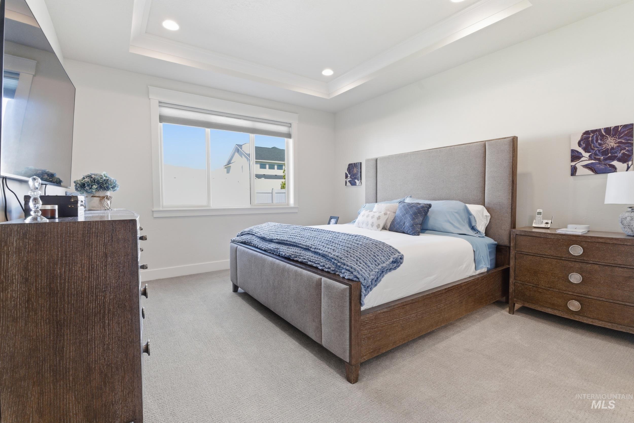 6347 South Utmost Lane Meridian, ID 83642 - Photo 20 of 37 Spacious bedroom with light gray carpeting and a tray ceiling featuring recessed lighting