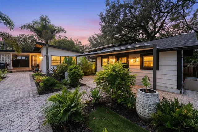 a front view of a house with a yard and a garage