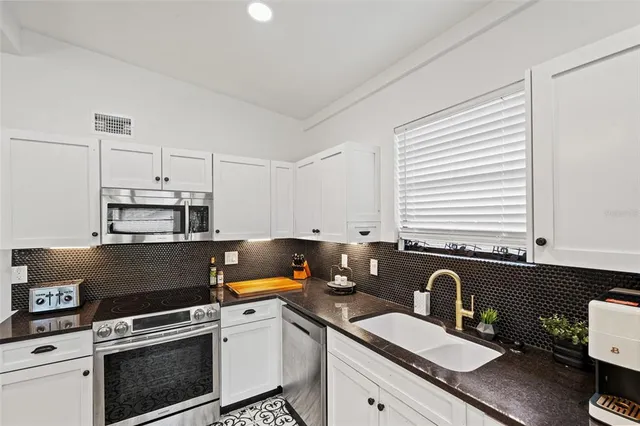 a bedroom with a bed and a flat tv screen