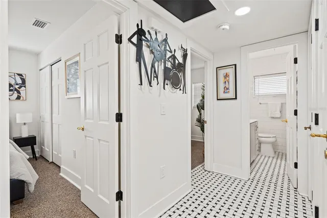 a bathroom with a sink a mirror a toilet and a window