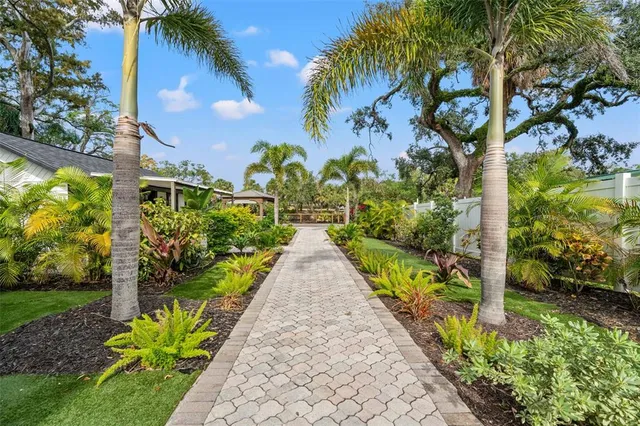 a view of a patio with couches and a table and chairs with plants