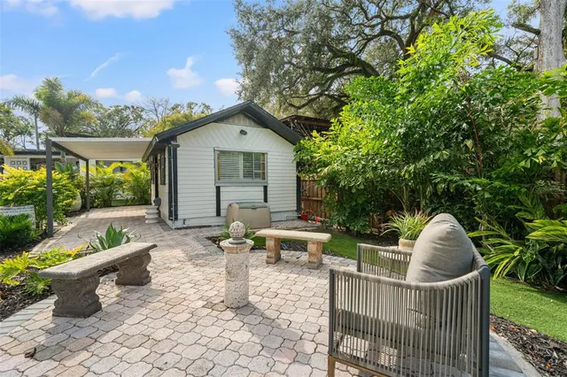 a view of a patio with table and chairs and potted plants