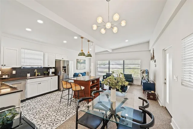 a view of a dining room with furniture and a chandelier