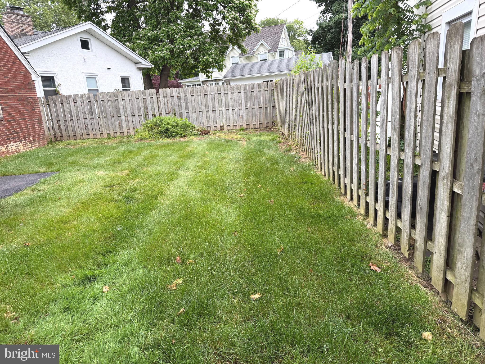 463 Burmont Road Drexel Hill, PA 19026 - Photo 35 of 39 a view of backyard with wooden fence and trees