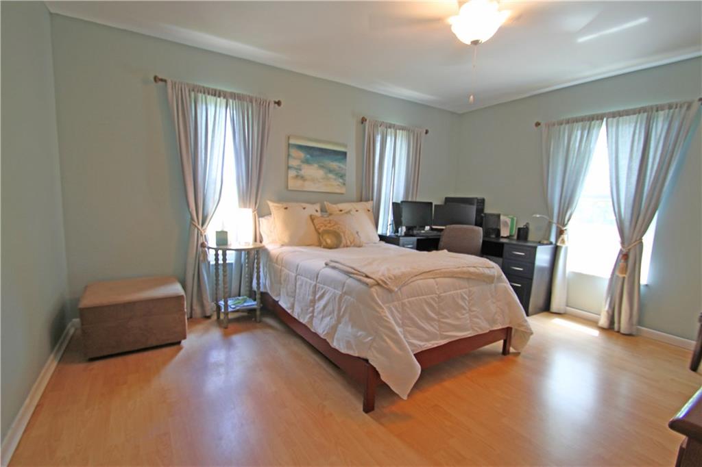 783 Northwest Spruce Ridge Drive Stuart, FL 34994 - Photo 11 of 29 a bed room with a bed window and a chair