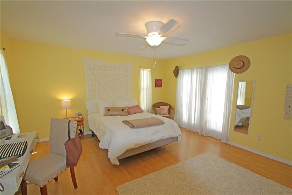 783 Northwest Spruce Ridge Drive Stuart, FL 34994 - Photo 12 of 29 a bedroom with a bed and a chandelier