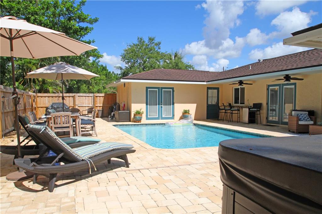 783 Northwest Spruce Ridge Drive Stuart, FL 34994 - Photo 19 of 29 a view of a backyard with a patio and fire pit