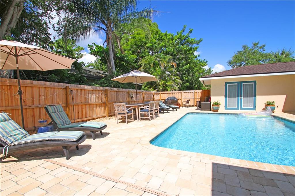783 Northwest Spruce Ridge Drive Stuart, FL 34994 - Photo 20 of 29 a view of backyard with swimming pool and furniture