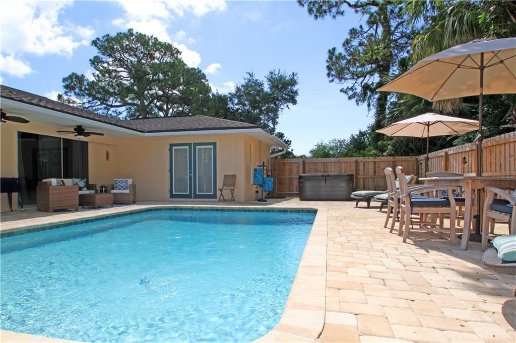 783 Northwest Spruce Ridge Drive Stuart, FL 34994 - Photo 24 of 29 a view of a house with backyard sitting area and garden