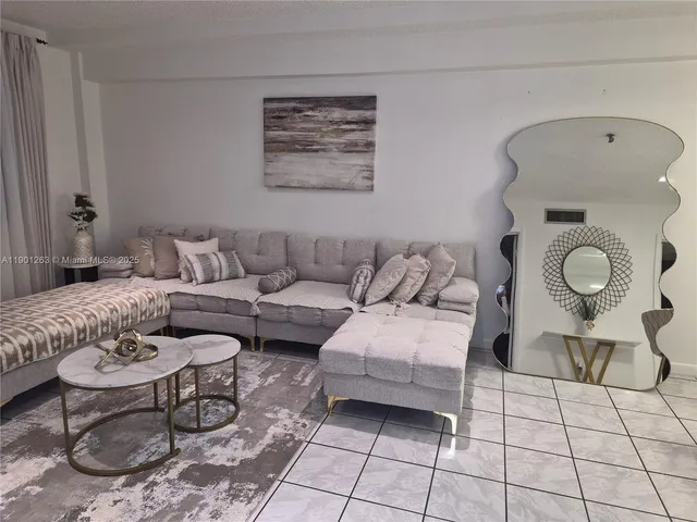 a living room with furniture and white walls