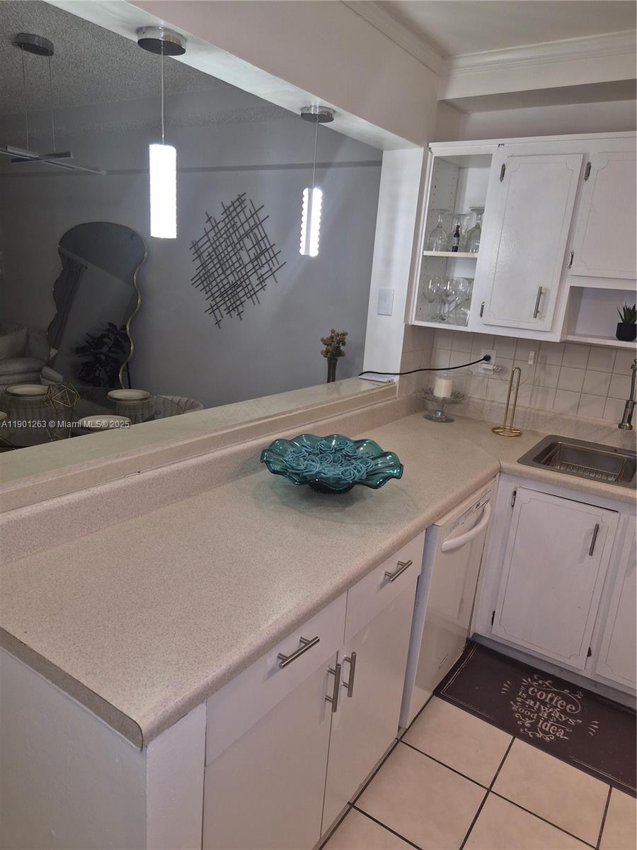 201 180th Drive, Unit 411 Sunny Isles Beach, FL 33160 - Photo 14 of 53 a kitchen with a sink and cabinets