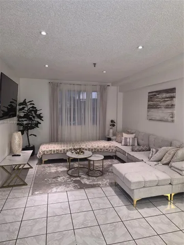 a kitchen with stainless steel appliances granite countertop a dining table and chairs