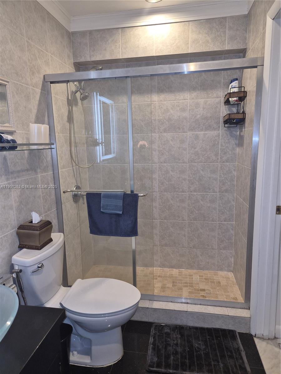 201 180th Drive, Unit 411 Sunny Isles Beach, FL 33160 - Photo 22 of 53 a bathroom with a toilet and a shower
