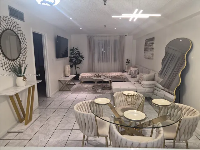 a kitchen with stainless steel appliances a refrigerator sink and cabinets