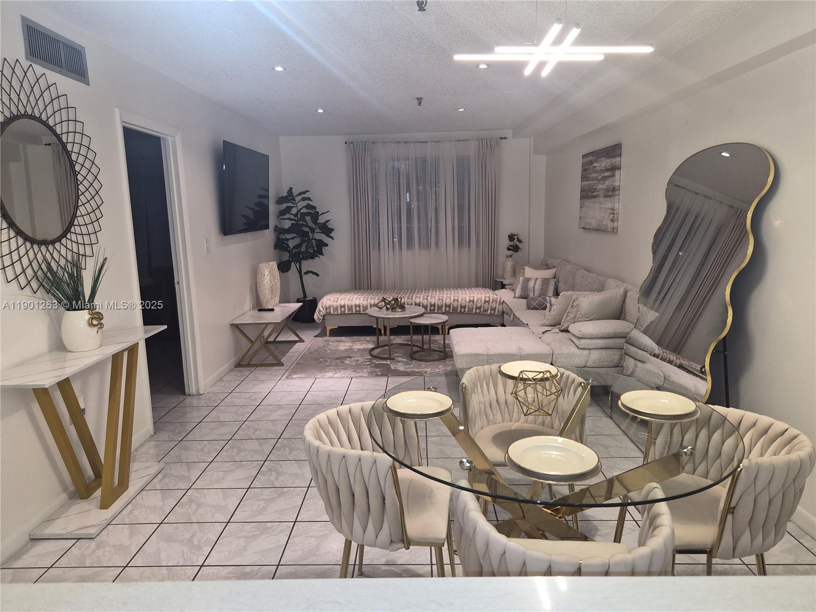 201 180th Drive, Unit 411 Sunny Isles Beach, FL 33160 - Photo 53 of 53 a dining room with furniture and wooden floor