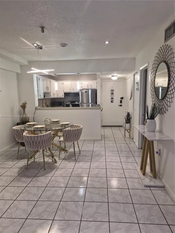 a bedroom with a bed and a flat tv screen on the dresser