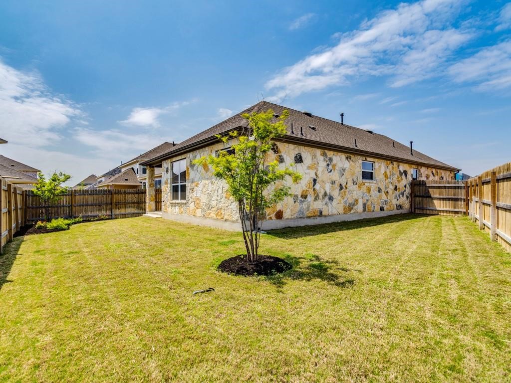 4210 Birdwatch Loop, Unit 2 Pflugerville, TX 78660 - Photo 27 of 31 A private, fenced yard boasts natural stone construction and ample green space for outdoor activities.