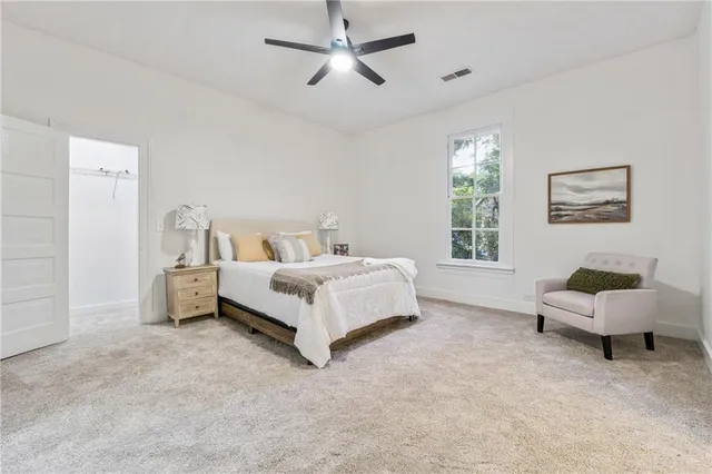 a bed room with a bed and a chair