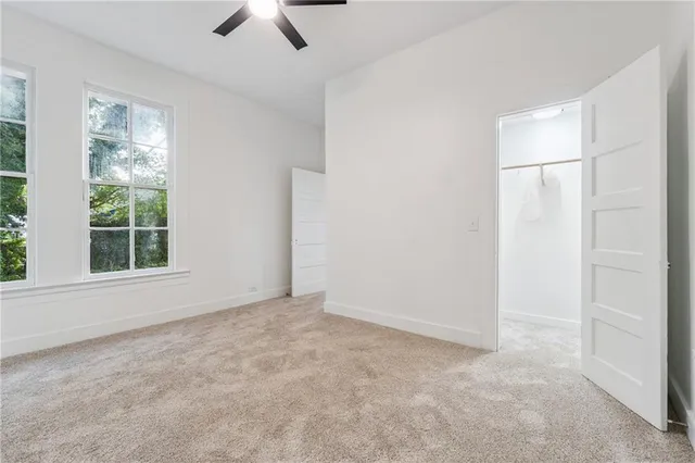 an empty room with windows and closet