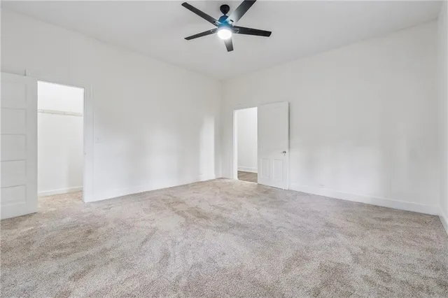 an empty room with closet and windows