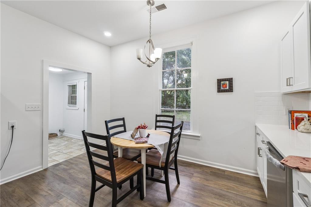 1820 Cassville Road Northwest Cartersville, GA 30121 - Photo 9 of 24 a view of a dining room with furniture window and wooden floor