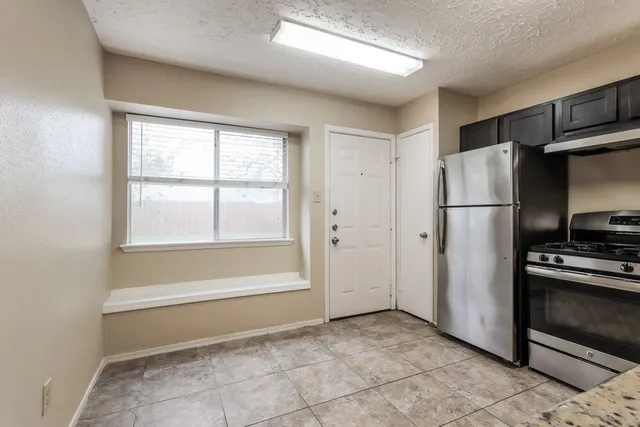 a view of a kitchen with a refrigerator cabinets and a window
