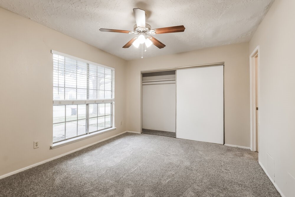 2438 Autumn Springs Lane Spring, TX 77373 - Photo 9 of 16 an empty room with chandelier fan and windows