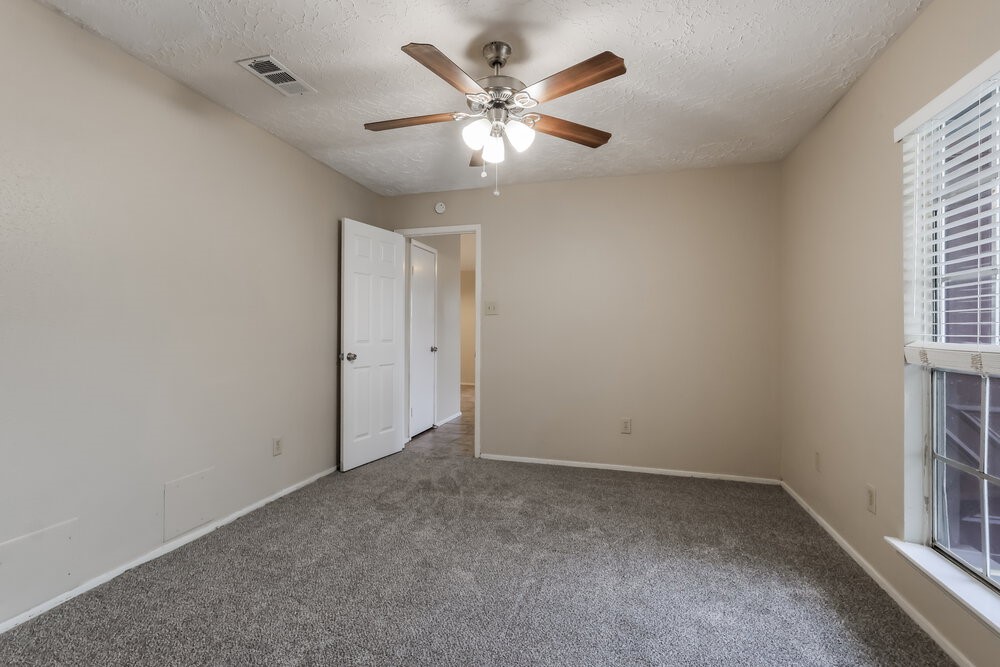 2438 Autumn Springs Lane Spring, TX 77373 - Photo 10 of 16 an empty room with ceiling fan and window